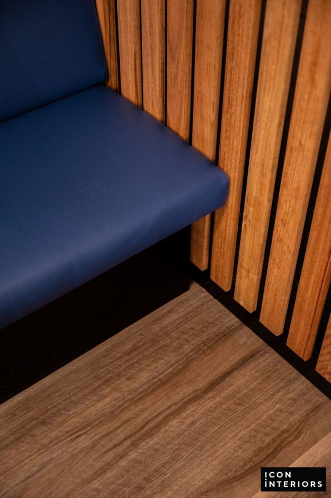 Restaurant blue couch and Timber wall fitting